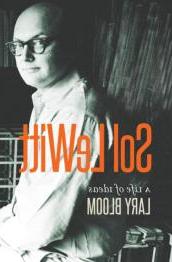 Image of artist, bald with glasses, with book title in orange.